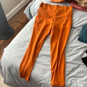 Rust Orange Leggings Athleta  Salutation Stash Pocket Right